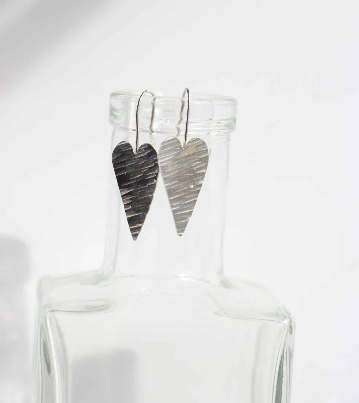 Heart shaped earrings with hammered texture